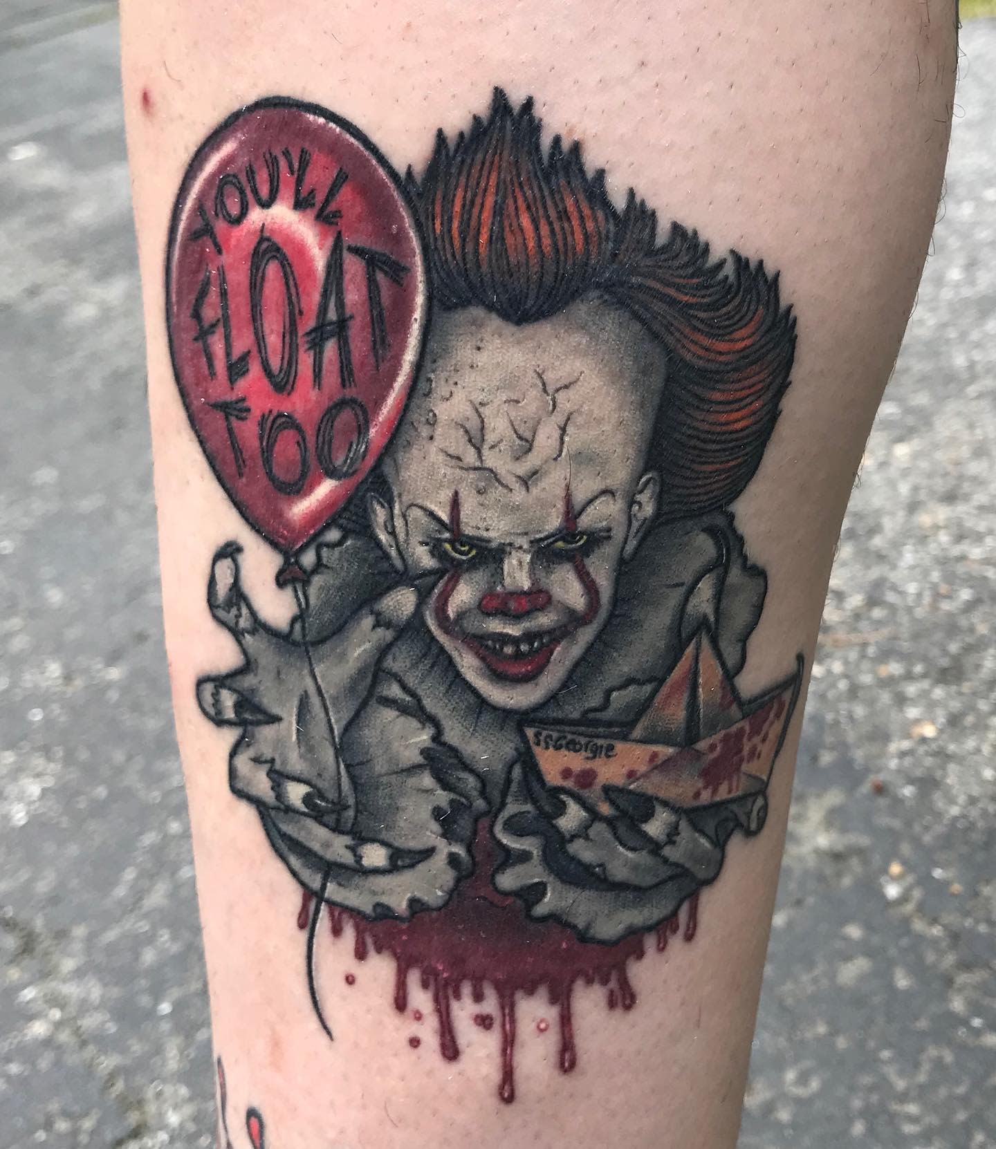 Pennywise tattoo with a red balloon, the phrase "You'll Float Too," and the S.S. Georgie boat